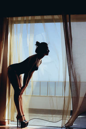 Amazing woman dancing on ocean outdoors background. Attractive female enjoying doing training, open air outside. Holiday, freedom, luxury relaxation style and happiness. Blowing fresh breeze horizonの写真素材