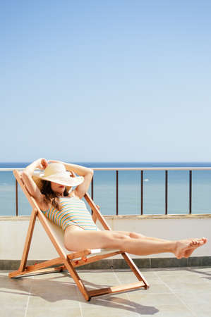 Attractive woman relaxing on holiday sunny outdoors background. Luxury vacation summertimeの写真素材