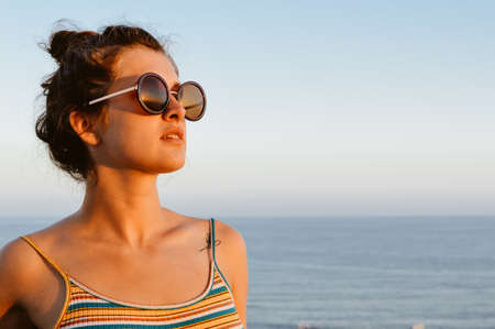 Attractive woman relaxing on holiday sunny sky outdoors background. Luxury vacation summertimeの写真素材