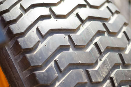 Close-up detail of car tires. Macro photography textured transportation pattern concept, abstract surface backgroundの写真素材