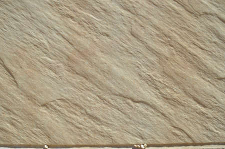 Closeup on ceramic tile detailed surface rough marbled textured backgroundの写真素材
