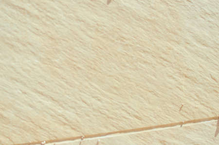 Closeup on ceramic tile detailed surface rough marbled textured backgroundの写真素材