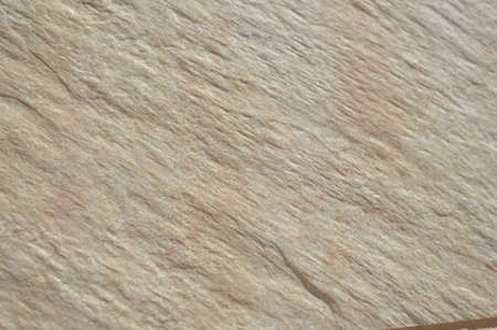 Closeup on ceramic tile detailed surface rough marbled textured backgroundの写真素材