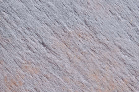 Closeup on ceramic tile detailed surface rough marbled textured backgroundの写真素材