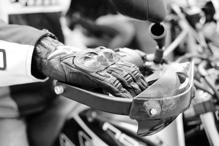 Black and white photography of leather glove on motorbike handlebar. closeupの写真素材