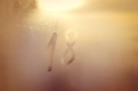New year resolution, 2018 sign on frost patterns window blurry textured seasonal natural backgroundの写真素材