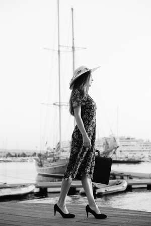 Back side view of attractive woman having fun enjoying summer holiday weekend background. Harbor outdoors, amazing dreamy marine vacation freedom pleasure summertime escape conceptの写真素材