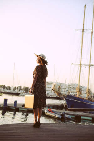 Back side view of attractive woman having fun enjoying summer holiday weekend background. Harbor outdoors, amazing dreamy marine vacation freedom pleasure summertime escape conceptの写真素材