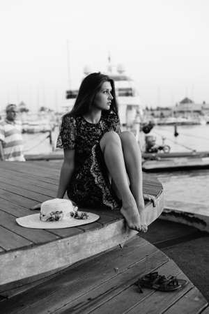 Side view of attractive woman having fun enjoying summer holiday weekend background. Harbor outdoors, amazing dreamy marine vacation freedom pleasure summertime escape conceptの写真素材
