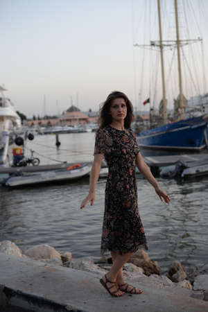 Side view of attractive woman having fun enjoying summer holiday weekend background. Harbor outdoors, amazing dreamy marine vacation freedom pleasure summertime escape conceptの写真素材