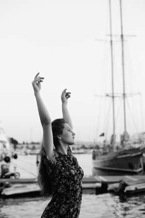 Side view of attractive woman having fun enjoying summer holiday weekend background. Harbor outdoors, amazing dreamy marine vacation freedom pleasure summertime escape conceptの写真素材