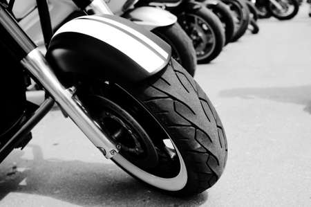 Black and white photography of group motorbikes parked together on outdoors backgroundの写真素材