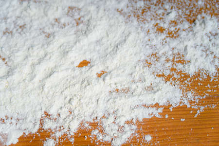 Top side view on white flour on rustic wooden table background, closeup of healthy cooking copyspace surface at home or restaurant, fabric plantの写真素材