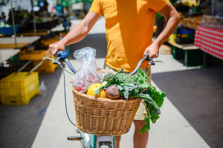 People buying fruits and vegetables. Summer outdoors farm market shopping background. Real purchasing selling natural healthy lifestyle candid closeup image.の写真素材