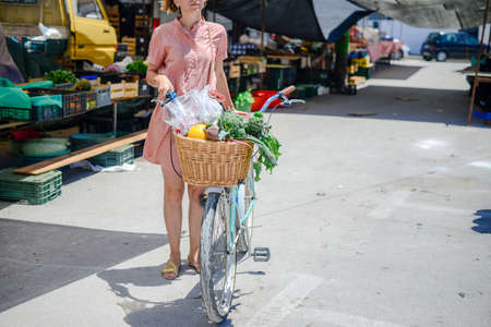 People buying fruits and vegetables ingredient. Summer outdoors farm market shopping background. Casual purchasing selling real natural healthy lifestyle candid closeup image.の写真素材