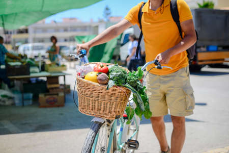 People buying fruits and vegetables. Summer outdoors farm market shopping background. Real purchasing selling natural healthy lifestyle candid closeup image.の写真素材