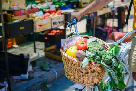 People buying fruits and vegetables. Summer outdoors farm market shopping background. Real purchasing selling natural healthy lifestyle candid closeup image.の写真素材