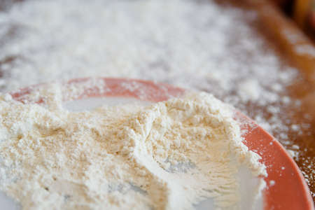 Top side view on white flour on rustic wooden table background, closeup of healthy cooking copyspace surface at home or restaurantの写真素材
