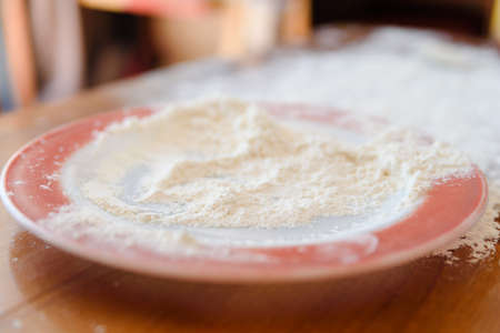 Top side view on white flour on rustic wooden table background, closeup of healthy cooking copyspace surface at home or restaurantの写真素材
