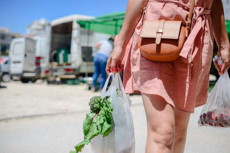 Adult person buying, selecting choosing fresh food abstract background, light day shop market. green commodity groceries consumption life checkoutの写真素材