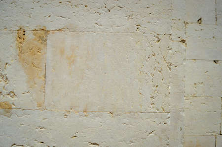 Closeup of natural pattern of stone wall building textured backgroundの写真素材