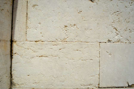 Closeup of natural pattern of stone wall building textured backgroundの写真素材