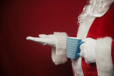 Relaxing Santa Claus drinking holding hot mug, festive leisure lifestyle closeup image. Merry Christmas and Happy New Year amazing excitement joyful seasonal holidays time!の写真素材