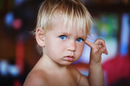 beauty blonde young boy with blue eyes in thailandの写真素材