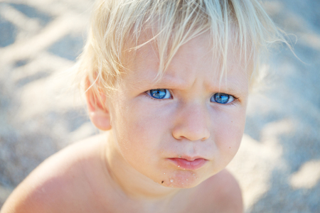 little toddler with blue eys in thailand beachの写真素材