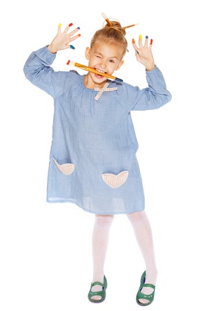 A little painter with colored fingers and a charming smileの写真素材