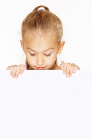 Little girl with blank sign isolated on whiteの写真素材