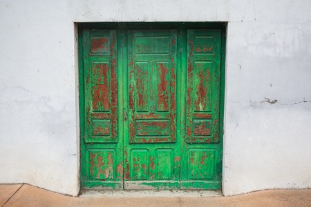 Old rustic wooden door painted in greenの写真素材