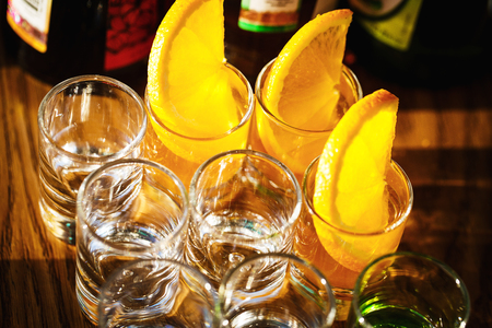 Drink shots and a slice of fresh fruitの写真素材
