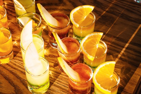 Drink shots and a slice of fresh fruitの写真素材