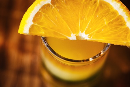 Drink shots and a slice of fresh fruitの写真素材