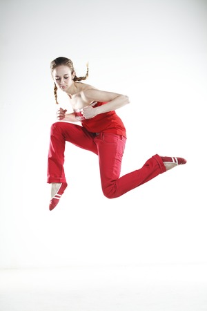 Young girl dancer doing jumps and difficult elementsの写真素材