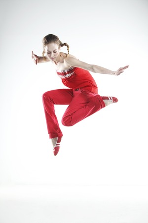 Young girl dancer doing jumps and difficult elementsの写真素材