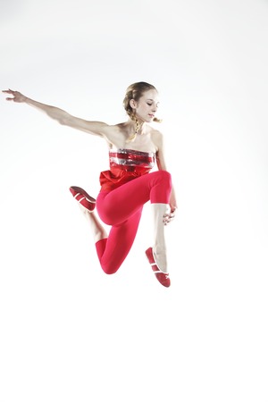 Young girl dancer doing jumps and difficult elementsの写真素材
