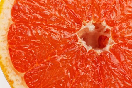Slice a fresh juicy red round grapefruitの写真素材
