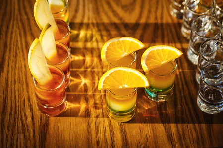 Drink shots and a slice of fresh fruitの写真素材