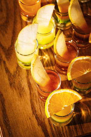 Drink shots and a slice of fresh fruitの写真素材