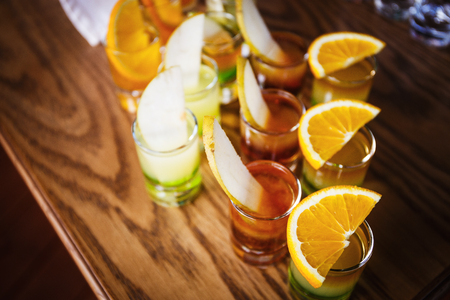 Drink shots and a slice of fresh fruitの写真素材