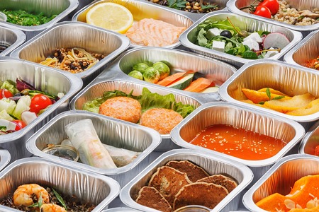 Separate portions of different food into containersの写真素材