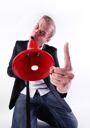 A crazy businessman shouting through a megaphoneの写真素材