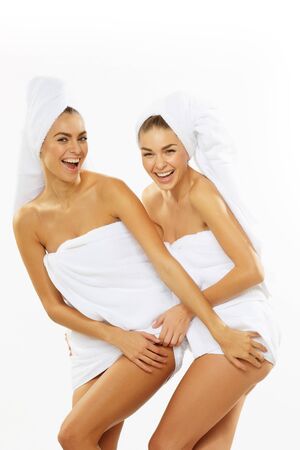 Two happy teen girl after shower in towelsの写真素材