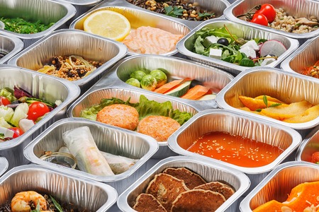 Separate portions of different food into containersの写真素材