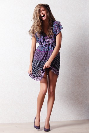Beautiful smiling girl in dress posing for the cameraの写真素材