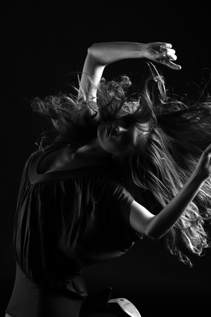 Black and White image of dancing girl with long hairの写真素材