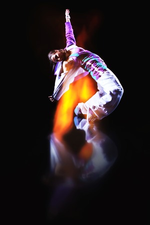Girl dancer in motion with special light effectの写真素材