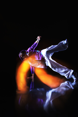 Girl dancer in motion with special light effectの写真素材